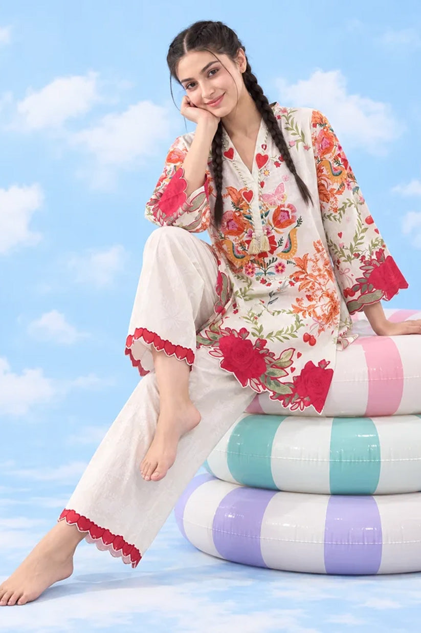 Two-piece lawn co-ord seated on pastel pool rings