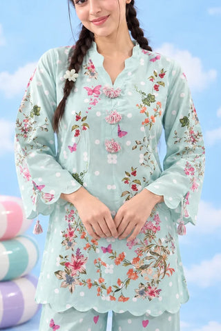 Close-up of tassel neckline and floral print detail