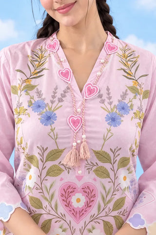 Close-up of heart appliqué neckline and tassel detail